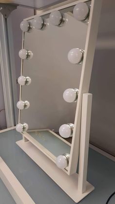 a white vanity mirror sitting on top of a counter