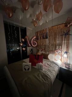 a bedroom with balloons and streamers hanging from the ceiling