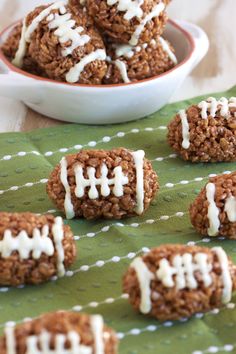 football cookies with white icing in a bowl