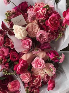 a bouquet of pink and white flowers with a price tag