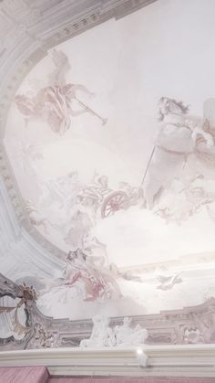 the ceiling is painted with white and pink paint, while some statues are on it