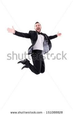 a man jumping in the air with his arms wide open and hands out, wearing a suit