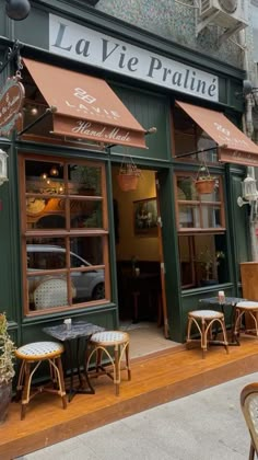 the outside of a restaurant with tables and chairs