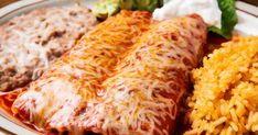 an enchilada plate with rice, beans, and other mexican food items