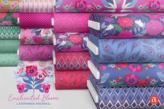 a stack of colorful fabrics with flowers on them