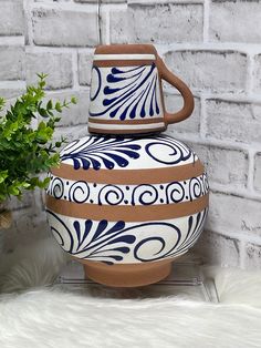 Beautiful hand crafted in the area of Jalisco, Mexico   Ceramic/terracotta water jug/ botellon 12" tall with cup 4qts/128oz capacity Cup 5" - 16oz Sturdy Food grade Perfect gift, beautiful decoration for home or office, multipurpose- flower vase, planter, kitchen use or just decor in your living room. ⚠️Hand wash before using.  ⚠️Hand wash only, after washing allow to air dry complete leaving it on a dish drying rack.  Do not store when wet. *⚠️MUST READ BEFORE PURCHASING** Botellon is not to be used on gas and or electric stove. May have imperfections such as bumps, scrapes, unevenness, paint stains, stains, spots due to its hand crafted nature** Jarritos With Flowers, Mexican Pottery Decor, Mexican Clay Cups, Vintage Mexican Pottery, Talavera Design, Mexican Kitchen Decor, Mexican Pottery Pitchers & Carafes, Mexican Pottery Pots & Planters, Mexican Party Decorations