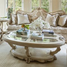 a living room filled with furniture and lots of pillows on top of the couches