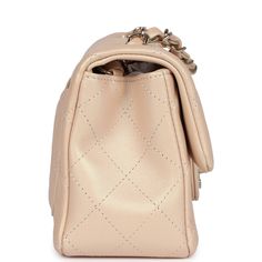 This Chanel mini classic rectangular flap bag is of iridescent beige lambskin leather with light gold tone hardware and has a front flap with signature CC turnlock closure, rear half moon pocket, single interwoven iridescent beige leather and light gold chain link shoulder/crossbody strap.The interior is lined in iridescent beige leather and features a zipper pocket with Chanel pull and an open pocket below.Collection: 22C (RFID Chip)Origin: FranceCondition: New and never worn (plastic on hardware)Accompanied by: Chanel box (damaged), Chanel dustbag, felt and COA cardMeasurements: 8" width x 5" height x 2.5" depth; 20" strap drop Chanel Mini Rectangular, Chanel Box, Mini Classic, Chanel Mini, Celine Bags, Bottega Veneta Shoulder Bag, Exclusive Bag, Flap Bag, Debit Card