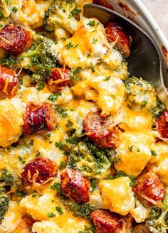 a casserole dish with broccoli, cheese and sausage