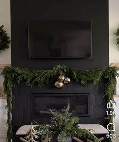 a living room decorated for christmas with greenery on the mantel and fireplace mantle