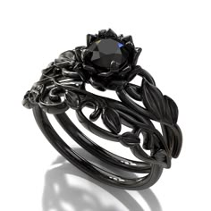 "If you're looking for an engagement ring like no other, stop right here. This AMAZING piece of fine jewelry is the perfect expression of your eternal love. Its BLACK colors bring out the beauty of this ring. This engagement ring is created of gleaming, 14kt black gold, carved into an elaborate leaf design at the top. A striking black diamond sits boldly at the center, surrounded by black gold petals, forming the eye-catching image of a lotus flower. ★See A Video Of This Amazing Ring Here★ https Simpul Dasi, Black Gold Engagement Rings, Gothic Engagement Ring, Black Diamond Engagement Ring, Flower Engagement, Cute Engagement Rings, Black Engagement Ring, Black Wedding Rings, Black Diamond Engagement