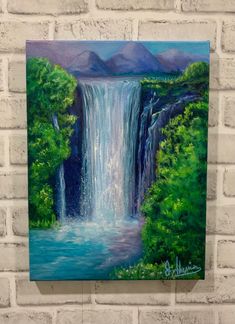 a painting of a waterfall on a brick wall