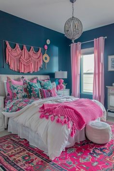 a bedroom with blue walls, pink curtains and rugs on the floor is decorated in bright colors