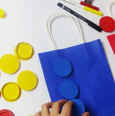 a person is cutting out circles on a paper bag