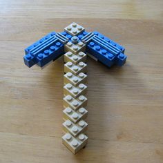 a lego cross sitting on top of a wooden table