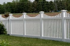 a white picket fence in the grass