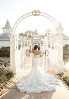 a woman standing in front of a white gate