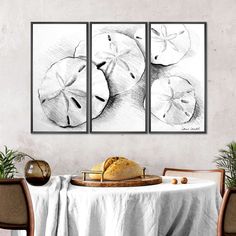 a table with some food on it and two pictures hanging above the table in front of it