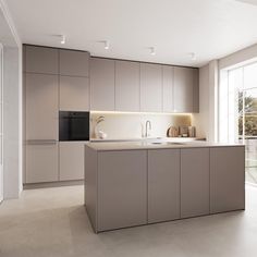 a modern kitchen with an island countertop and stainless steel appliances on the wall, along with sliding glass doors leading outside