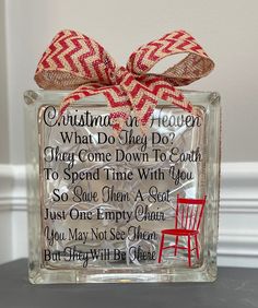 a glass block with a red chair on it and a poem written in the bottom