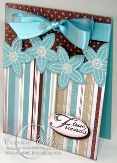 a close up of a card with a bow on the front and flowers on the back