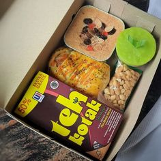 a box filled with food sitting on top of a table