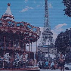 a carousel in front of the eiffel tower