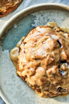 a close up of a plate of food with meat and gravy on it