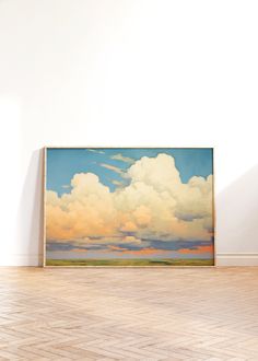 an empty room with a large painting on the wall and hard wood flooring in front of it