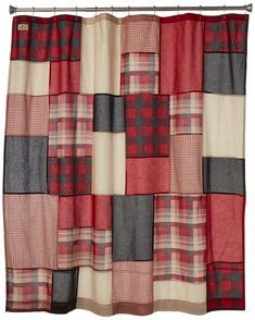 a red and gray shower curtain hanging on a metal rod