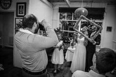 a group of people standing around each other in a room