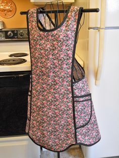 an apron hanging on a rack in a kitchen