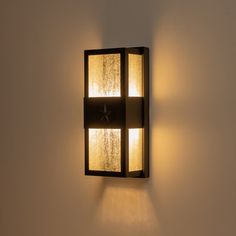 a wall light that is on the side of a wall with two lights in it