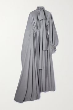 This dress made its debut at Balenciaga's Fall '23 show - the feminine shape contrasted with the sportier, streamlined styles that filled the runway. Cut from silver stretch-satin, it's ruched at the waist to create pleats through the body and has a cape-style sleeve that trails dramatically on the floor. Elegant Dresses Hijab, Silver Satin Dress, Balenciaga Dress, Ruched Waist Dress, Camino Real, Ruched Maxi Dress, Aesthetic Dress, Grey Midi Dress, Dress Design Sketches