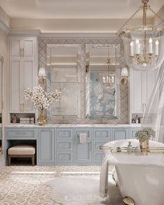 an elegant bathroom with blue cabinets and white bathtub, chandelier, vanity mirror, toilet and sink