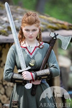 a woman with red hair holding two swords