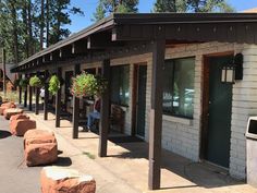 the outside of a building with several large rocks lined up along the side of it