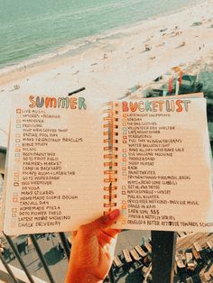 someone is holding up a summer bucket list