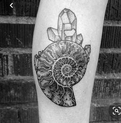 a black and white photo of a tattoo design on the left calf's leg