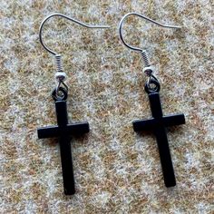 A pair of super cute Cross earrings.  These are black metal crucifix earrings.  That are great quality.  Silver alloy hooks complete these lovey pieces. Gothic Black Hypoallergenic Earrings, Black Cross Earrings For Gift, Black Cross Earrings As Gift, Black Cross-shaped Earrings For Gift, Black Metal Cross Earrings, Black Cross Metal Earrings, Black Gothic Cross Earrings, Black Cross Earrings For Pierced Ears, Crucifix Earrings