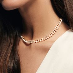 The Pearl and Diamond Tennis Necklace combines the timeless elegance of pearls with the dazzling brilliance of diamonds to create a piece of jewelry that's both classic and striking. The contrast between the lustrous freshwater pearls and the sparkling diamonds makes for a stunning visual effect. Perfect for any formal occasion or as a luxurious everyday accessory. Available in 14K Yellow Gold Diamond weight = 2.63 carats Chain length = 14in with adjustable 2in chain Diamond Pearl Choker Necklace, Pearls And Diamonds Necklace, Luxury Elegant Tennis Necklace For Formal Occasions, Nikkah Outfit, Pearl Diamond Necklace, Diamond Tennis Necklace, Bridal Choker, Pearl And Diamond Necklace, Wedding 2025