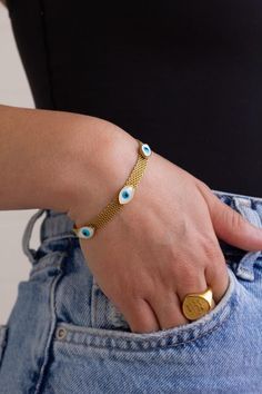 Adjustable Gold Evil Eye Bracelet | Hypoallergenic & Tarnish Resistant Protect your energy in style with our stunning adjustable Gold Evil Eye Bracelet! Crafted from high-quality, 18k gold-plated stainless steel, this is believed to ward off negative energy and bring good fortune. The lobster clasp allows for a perfect, comfortable fit for most wrist sizes, making it an ideal everyday accessory. ✨ Key Features: 18k gold-plated stainless steel, hypoallergenic, and tarnish-resistant Evil eye charm for protection and good luck Adjustable design for a custom fit Evil Eye Charm Bracelet, Gold Spiritual Evil Eye Bracelet For Everyday, Trendy Gold Evil Eye Bracelet Gift, Gold Evil Eye Bracelet For Everyday, Trendy Gold Bracelets With Evil Eye, Trendy Gold Evil Eye Bracelet, Gold Resizable Round Evil Eye Bracelet, Adjustable Hypoallergenic Gold Evil Eye Bracelet, Minimalist Gold Bracelets With Evil Eye