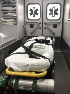 the back of an ambulance with medical supplies on it's bed and two doors