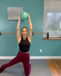 a woman is doing yoga with a ball