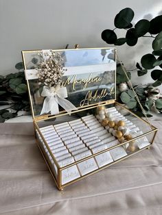 a box filled with lots of white and gold candies on top of a table