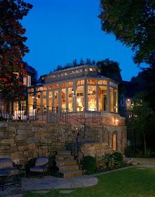 an elegant house lit up at night in the evening