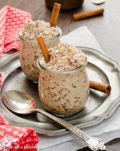 two small jars filled with oatmeal and cinnamon on a silver platter