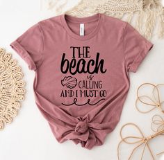 "The Beach Is Calling And I Must Go T-shirt, Beach Summer Shirt, Girls Weekend Tee,  Summer Vacation Top, Beach Matching Gift, Beach Tee, Family Vacation Tshirt, Summer Lover Shirt, Beach Summer Shirt, Summer Shirt, Beach Party Shirt, Summer Lover Shirt, The Beach Is Calling, And I Must Go, Family Vacation, Vacation Shirt, Beach Vibes Shirt, Beach Shirt, Girls Trip, Friends Vacation, Holiday Shirt This updated unisex essential fits like a well-loved favorite. Super soft cotton and excellent quality print makes one to fall in love with it over and over again. ------------- Fabrication ------------- 100% Combed ring spun cotton Made by specially treating the cotton fibers before spinning them into yarn. The result is stronger and smoother fabric. ------------- Unisex T-shirt Size Chart ----- Beach Holiday Cotton T-shirt, Beach Season Holiday Cotton T-shirt, Beach Holiday Graphic Print T-shirt, Graphic Print T-shirt For Beach Holiday, Cotton T-shirt For Beach Holiday, Letter Print T-shirt For Beach Season Holiday, Holiday Beach Tops With Letter Print, Letter Print Tops For Beach Holiday, Tequila Made Me Do It