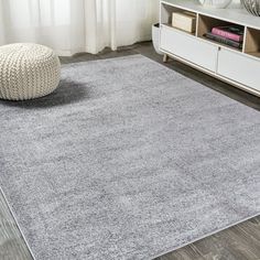 a large gray rug in a living room