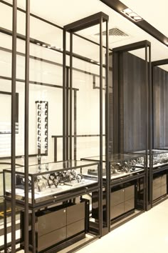 the inside of a jewelry store with lots of necklaces on display in glass cases